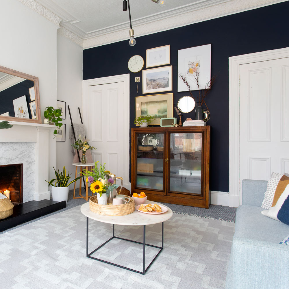 Living room with navy blue feature wall and picture gallery
